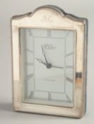 A SILVER UPRIGHT EASEL CLOCK by R. CARR, with bead edge. 6.5ins high x 4.5ins wide.