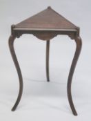 A TRIANGULAR TOP TABLE.