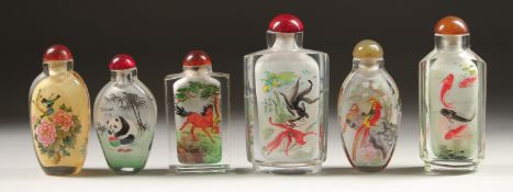 A COLLECTION OF SIX CHINESE SCENT BOTTLES AND STOPPERS painted with fish, pandas, birds, houses, and