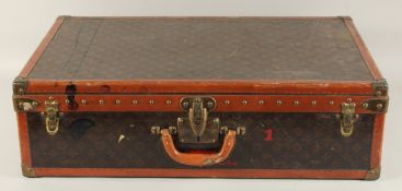 A LOUIS VUITTON SUITCASE. No. 81494, with Louis Vuitton label. Related label, bought from SAKS & Co.