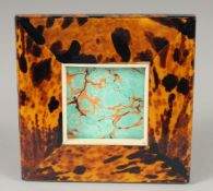 A FAUX TORTOISESHELL SQUARE FRAME. 5ins x 5ins