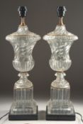 A GOOD PAIR OF GLASS URN SHAPED LAMPS AND BASES 2ft high.