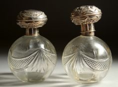 A PAIR OF SILVER TOP GLASS SCENT BOTTLES. London 1910.