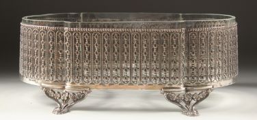 A CONTINENTAL SILVER MOUNTED GLASS JARDINIERE with period fretwork on four curving rose legs 12ins