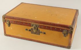 A LOUIS VUITTON SUITCASE. No. 736514. Plain leather with LV monogram banding. 25ins long x 15.5ins