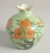 A SMALL GREEN GLAZE BULB VASE decorated with pomegranate blossom, six character mark to base. 12.5cm