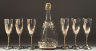 A SUPERB SILVER AND GLASS DECANTER, WINE COOLER AND SIX CHAMPAGNE GLASSES, made by GOLDSMITHS AND