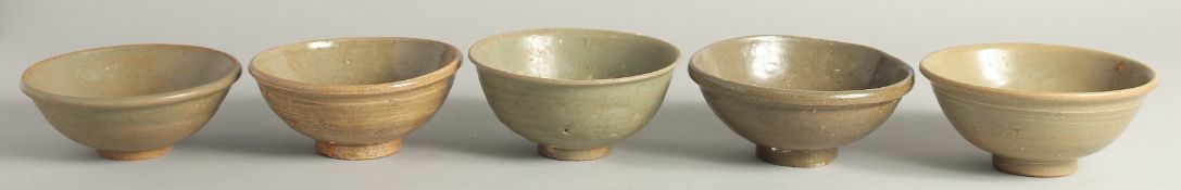 FIVE VARIOUS CELADON GLAZED BOWLS. 5.5ins diameter.
