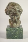 A SMALL BRONZE OF A BOY. 3.5ins long on a marble base