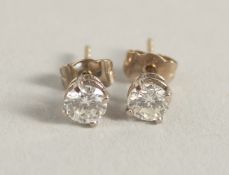 A GOOD PAIR OF SINGLE DIAMOND STONE EAR STUDS.