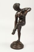 A 19TH CENTURY BRONZE STANDING NUDE on a circular base. 10ins high.