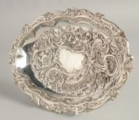 A VICTORIAN SILVER OVAL FRUIT BASKET with repousse decoration, on four bun feet. 11ins x 8ins.