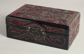 A CHINESE LACQUERED WOOD RECTANGULAR BOX with carved decoration and hinged lid. 21cm x 14cm