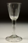 A GEORGIAN WINE GLASS with plain bowl 6.25ins high.