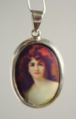 A SILVER AND ENAMEL GIRL PENDANT.