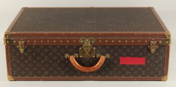 A LARGE LOUIS VUITTON SUITCASE. No. 981622. Label faded. Lock no. 1078192. 31.5ins long x 20.5ins