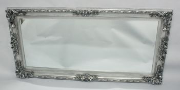 A LARGE GILTWOOD MIRROR. 5ft 6ins x 2ft 8ins.