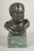 A SMALL BRONZE OF A ROMAN. 4ins high on a marble base.