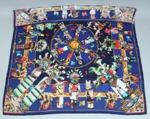 AN HERMES SILK SCARF, puppet and toy on a blue ground. 34ins x 334ins in a Hermes box.