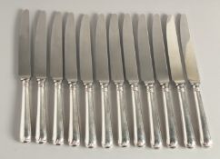 A SET OF TWELVE SILVER HANDLED DESSERT KNIVES.