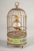 A SMALL MUSICAL BIRD CAGE CLOCK 6ins high.