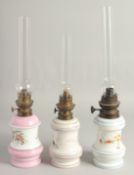 THREE FRENCH PORCELAIN OIL LAMPS AND GLASS FUNNELS.