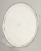 A GOOD GEORGE III SILVER SCOTTISH CIRCULAR SALVER with bead edge on three curving feet, with a crest