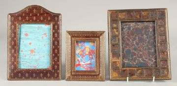THREE TOOLED MOROCCAN LEATHER PHOTOGRAPH FRAMES. 8ins x 7ins.