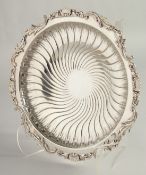 A FRENCH SILVER CIRCULAR WRYTHEN FLUTED FRUIT DISH with cast edge, with shells and acanthus, on four