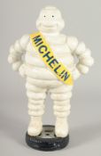 A CAST IRON 'MICHELIN MAN'. 1ft 3ins high.