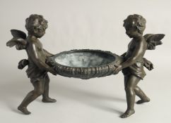 A GOOD 19TH CENTURY FRENCH SPELTER CENTREPIECE, a bowl held up by two cherubs.