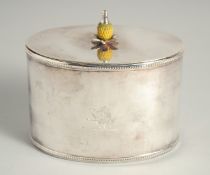 A REPRODUCTION SILVER PLATED OVAL TEA CADDY with pineapple final with crest.