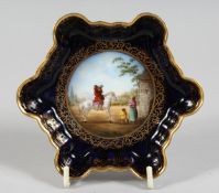 A SMALL VIENNA BLUE GROUND SHAPED DISH, a man on horseback Beehive mark, 4.75ins.