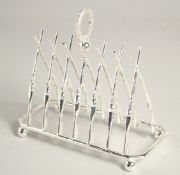 A SILVER PLATED SIX DIVISION TOAST RACK with cross guns,