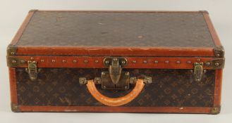A LOUIS VUITTON SUITCASE. Label faint, also retail label faint, with lift-out tray. Lock no. 065564.