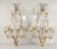 A PAIR OF ORNATE BRASS AND CUT GLASS WALL LIGHTS, of two tier form with four light fittings to each,