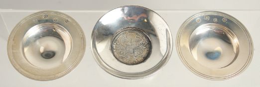 A SMALL PAIR OF SILVER CIRCULAR ARMADA DISHES, 3ins diameter. London 1970 and a small dish with