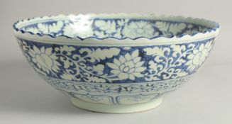 A VERY LARGE CHINESE BLUE AND WHITE PORCELAIN BOWL, for the Islamic market, with petal-formed edge