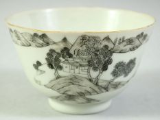 A CHINESE BLACK AND WHITE PORCELAIN BOWL, the exterior painted with a landscape scene, the base