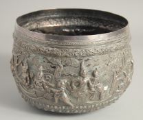 A LARGE INDIAN EMBOSSED SILVER BOWL, the exterior with embossed and chased decoration depicting