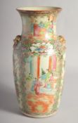A CHINESE CANTON FAMILLE ROSE PORCELAIN VASE, with moulded twin handles and painted with panels of