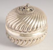 A SILVER CIRCULAR BOX AND COVER, the cover with naturalistic knop, ribbed decoration to the cover