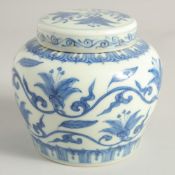 A CHINESE BLUE AND WHITE PORCELAIN JAR AND COVER painted with flora and vine. 11.5cm high