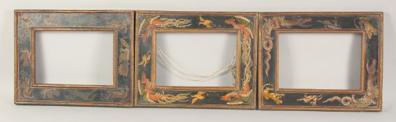 THREE 19TH CENTURY EASTERN HAND PAINTED WOODEN FRAMES, each painted with animals and mythological