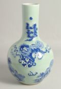A CHINESE CELADON GROUND BLUE AND WHITE VASE, decorated with foo dogs, 35cm high.