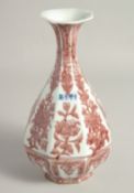 A CHINESE UNDERGLAZE RED PORCELAIN OCTAGONAL VASE, decorated with panels of flora, with four-