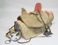 AN ARAB LEATHER SADDLE WITH EMBROIDERED COVER and matching under-blanket / cover, together with