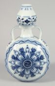 A CHINESE BLUE AND WHITE PORCELAIN MOON FLASK with twin handles and decorative yin-yang motif to