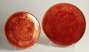 TWO CHINESE GILDED LACQUERED CIRCULAR PANELS, each decorated with a central landscape scene and