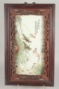 A CHINESE REPUBLIC PERIOD FAMILLE VERTE PORCELAIN PANEL, encased in a hardwood frame, the panel